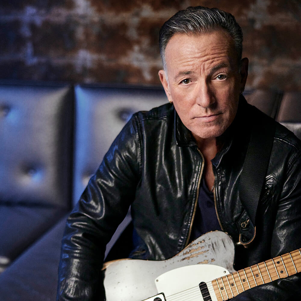 Photo of Bruce Springsteen holding a guitar