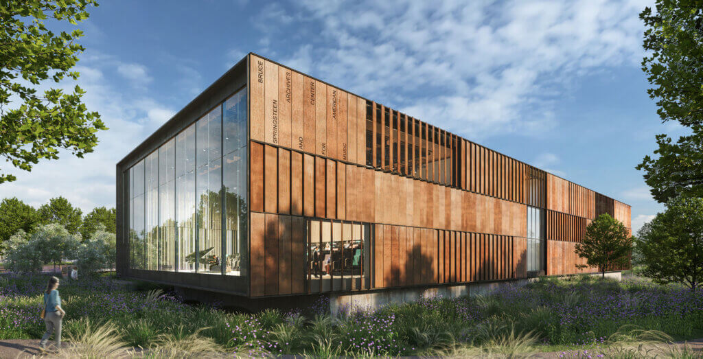 Rendering of a building clad in wood with a an entire wall that is glass. Behind the glass is a theater. The building is surrounded by native vegetation.